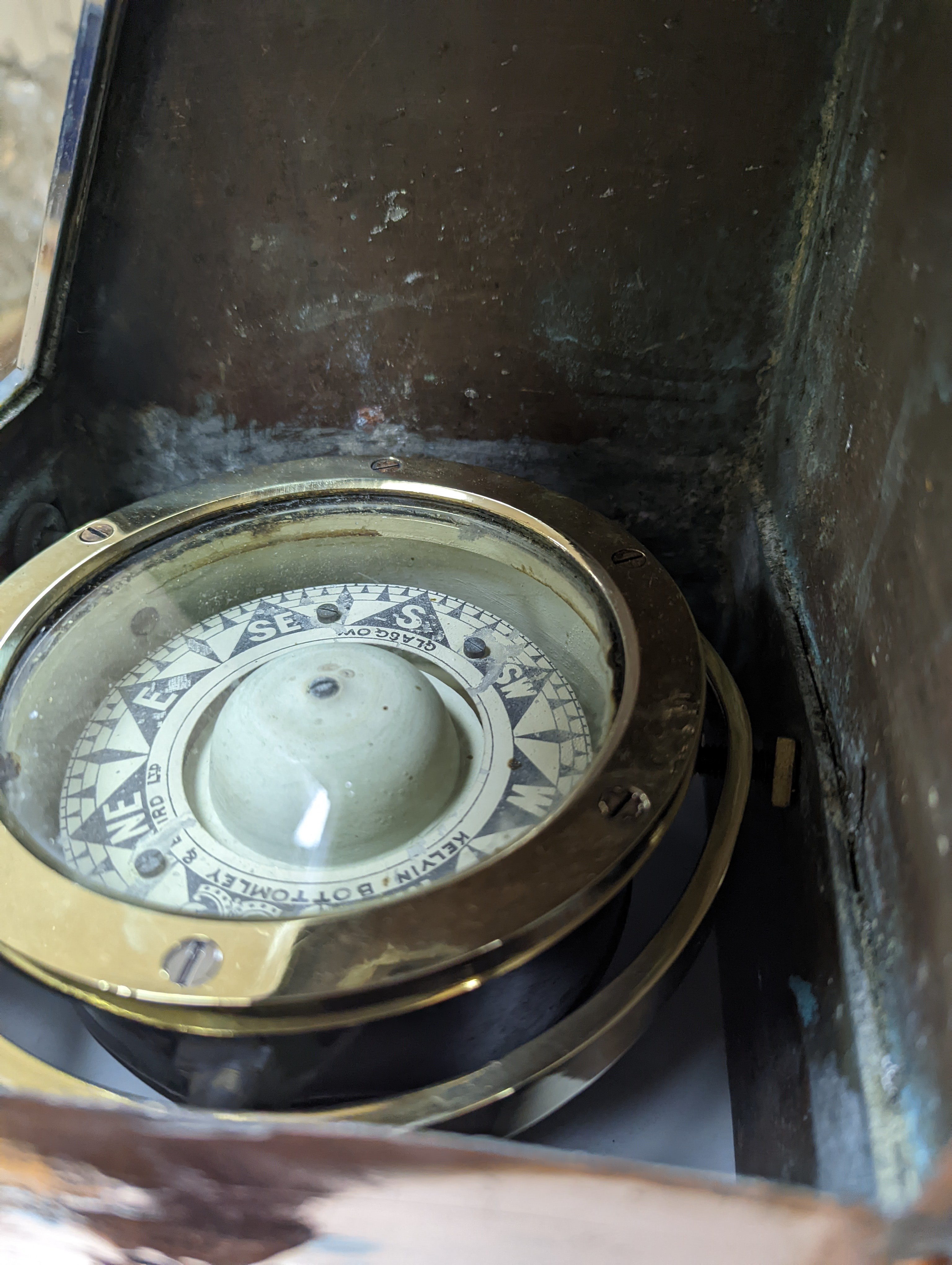 A copper ship's binnacle compass, a brass oil lamp, a brass jug and a copper kettle